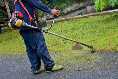 Low section of man working on road