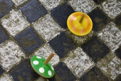 High angle view of spinning tops on floor