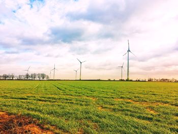 Group of windmills producing green energy in a field near diest belgium
