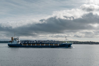 Ship sailing on sea against sky