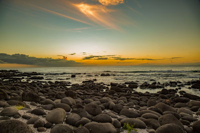 Sunset on the rocky beach of albion, mauritius.