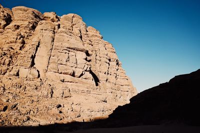 Low angle view of rock formations against sky