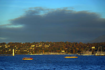 Boat sailing on sea against sky