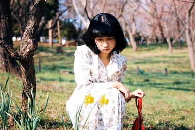 Portrait of a young woman in field