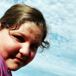 Portrait of cute girl against sky