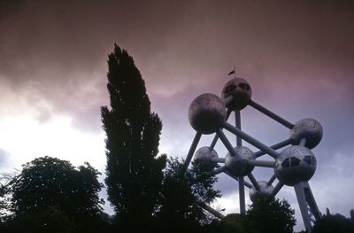 Low angle view of street light against cloudy sky