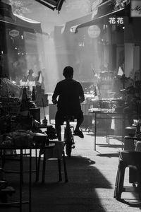 Rear view of people sitting on street