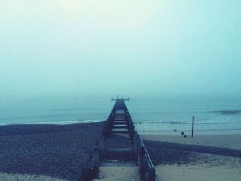 Scenic view of calm sea against cloudy sky