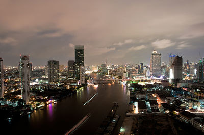 High angle view of illuminated city buildings against sky