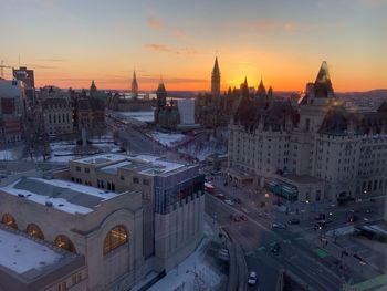 High angle view of buildings in city during sunset