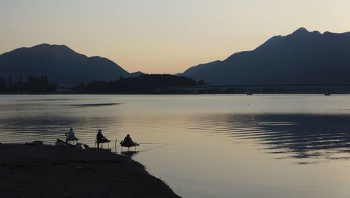 Scenic view of lake against sky during sunset