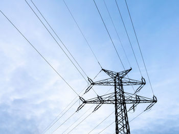 Low angle view of electricity pylon against sky