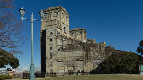 Low angle view of historic building against clear blue sky