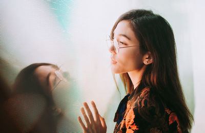 Portrait of woman looking at window