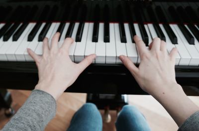 Close-up of woman playing piano