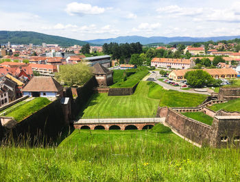 Houses and buildings in town against sky