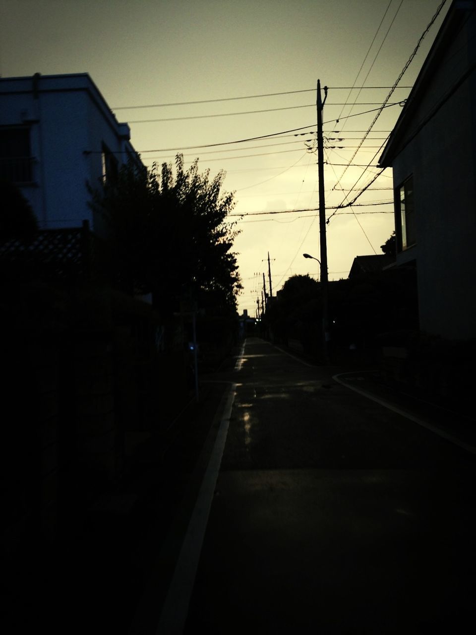 power line, electricity pylon, building exterior, transportation, the way forward, built structure, cable, architecture, electricity, sky, diminishing perspective, street, road, power cable, silhouette, vanishing point, power supply, tree, sunset, street light