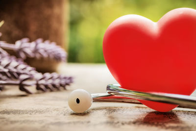 Close-up of stethoscope with heart shape toy on table