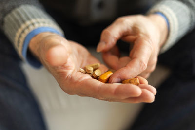 Midsection of man holding pills