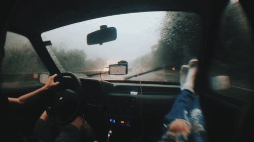 Man seen through car windshield