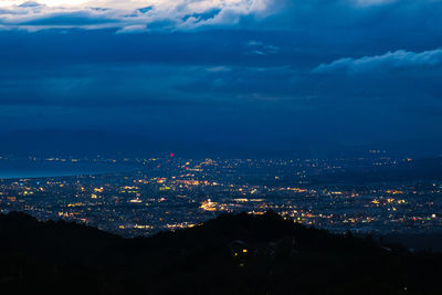 High angle view of illuminated buildings in city at night