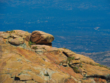 Rock formation on land against blue sky