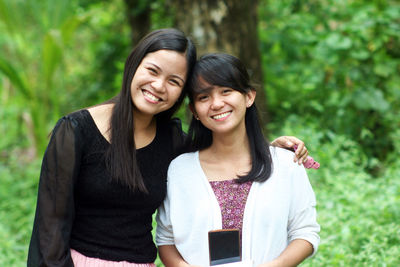 Portrait of smiling young woman with friend