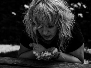 Woman holding pills outdoors