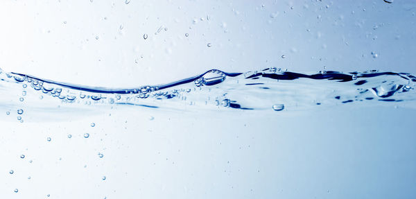 Close-up of water splashing against blue background