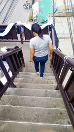 Rear view of woman walking on stairs
