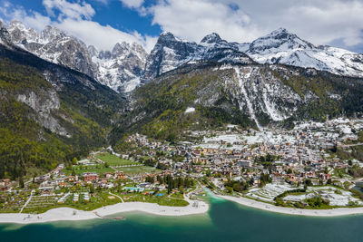 Scenic view of lake by snowcapped mountains against sky