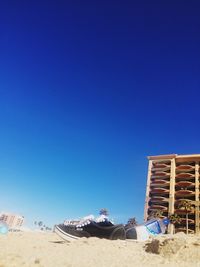 Panoramic view of beach against clear blue sky