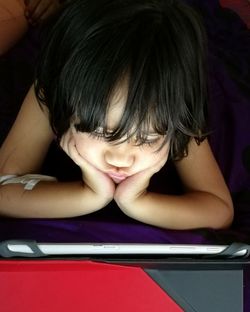 Close-up of boy reading book