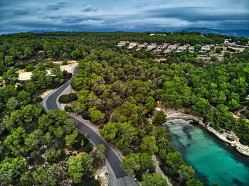 High angle view of river amidst trees against sky