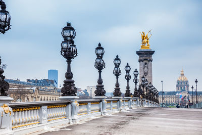 Street lights on bridge against buildings in city