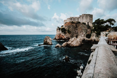 Panoramic view of sea and buildings against sky