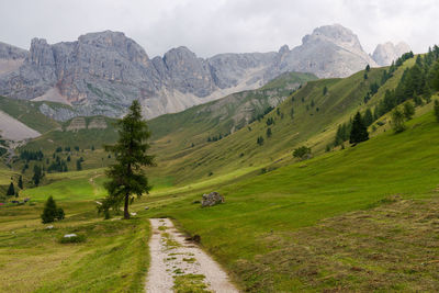 Scenic view of mountains against cloudy sky