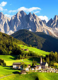 Scenic view of field and mountains against sky