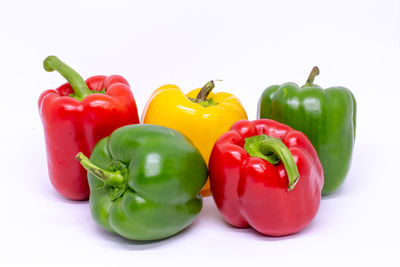 Close-up of red bell peppers against white background