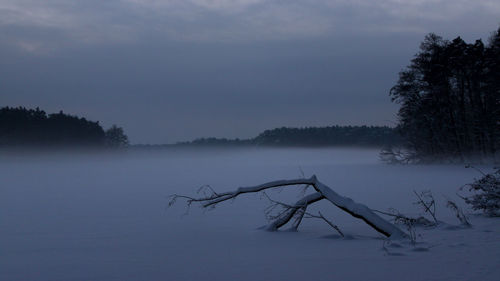 Scenic view of frozen lake against sky during winter