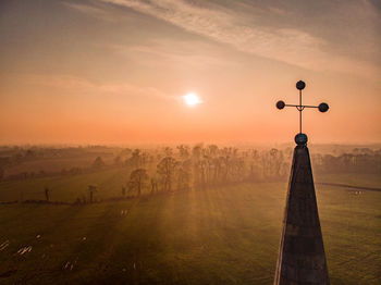 Scenic view of field against sky during sunset