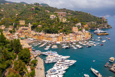 High angle view of townscape by sea against sky