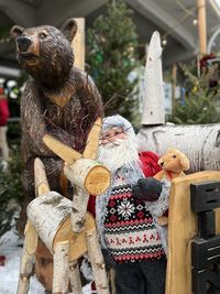 Bear and wooden reindeer with santa claus at a christmas