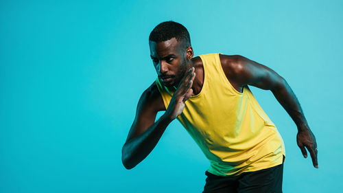 Man running against blue background