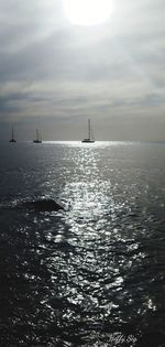 Sailboat in sea against sky