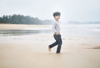 Full length portrait of boy on beach