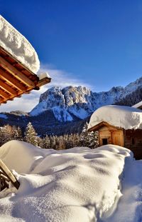 Scenic view of snowcapped mountains against clear blue sky