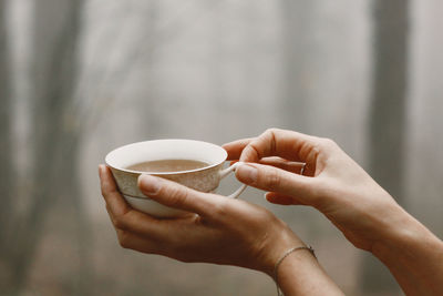 Cropped hand holding coffee