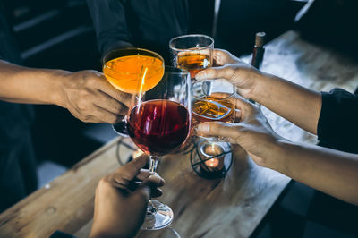 People toasting drinks at table