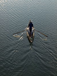 High angle view of a fisherman and paddeling in canoe